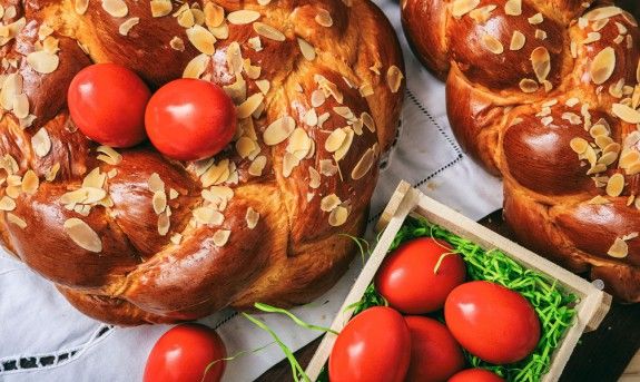 75594399 – easter traditional bread and red eggs on a table –  top view