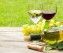 White and red wine glasses, wine bottle and white grape