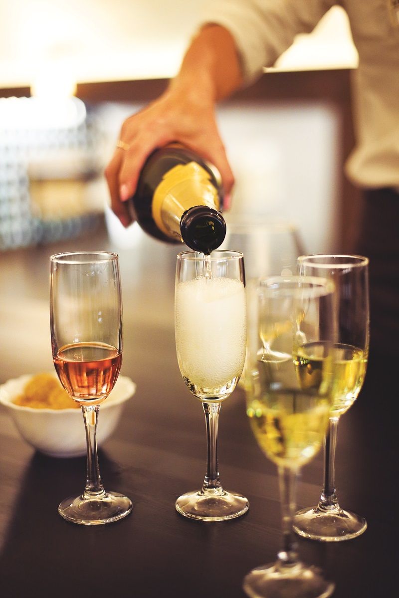 Champagne flutes are being filled on a digustation