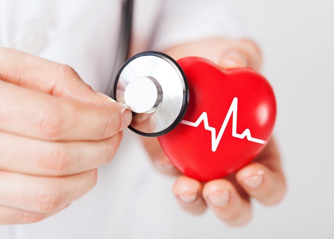doctor hands holding red heart and stethoscope