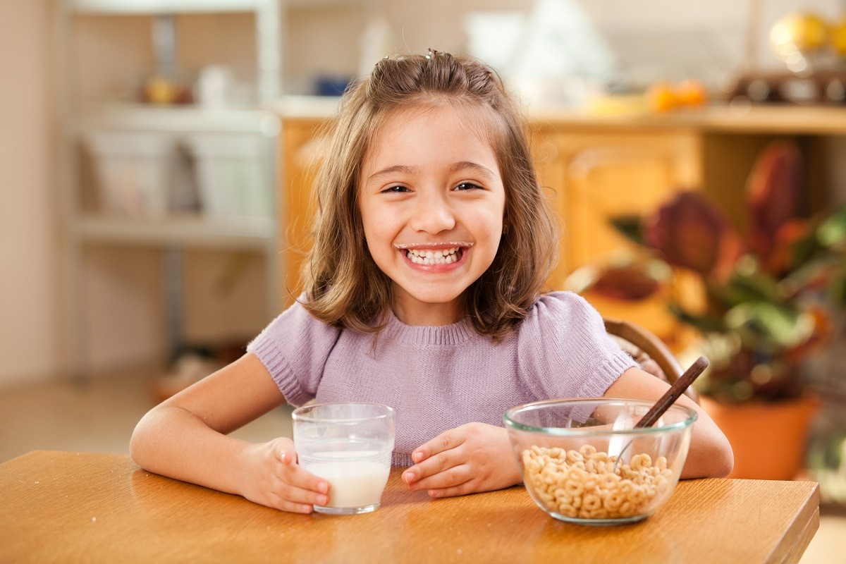13256288 – little girl having breakfast: milk moustache