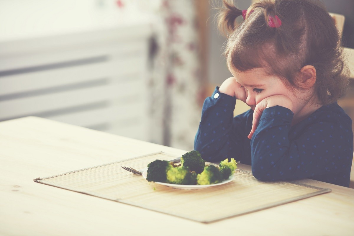 child girl does not like and not want to eat vegetables