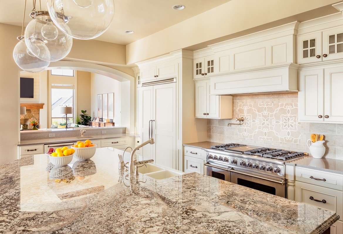 Kitchen with Island, Sink, Cabinets, and Hardwood Floors