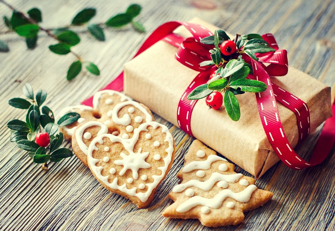 VintagecChristmas gift box and gingerbread cookies on wooden bac