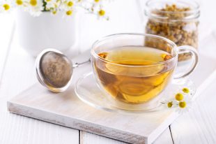 Healthy chamomile tea in a glass teacup