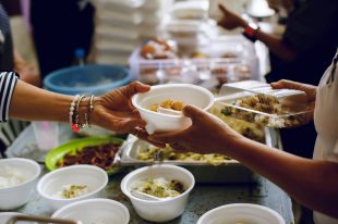 Feeding the poor to hands of a beggar. Poverty concept