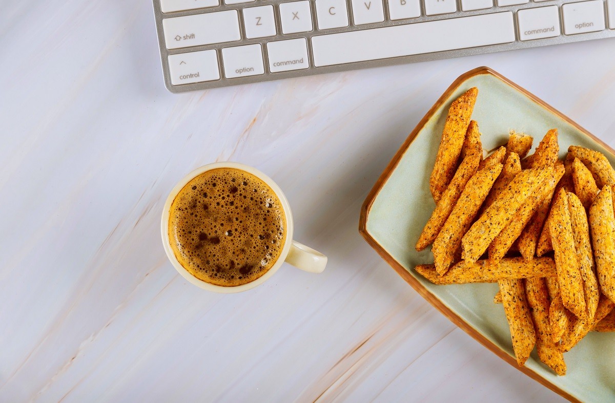 Layflat view to a with coffee and french fries computer keyboard
