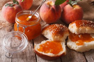 Homemade buns with peach jam close-up on the table. Horizontal