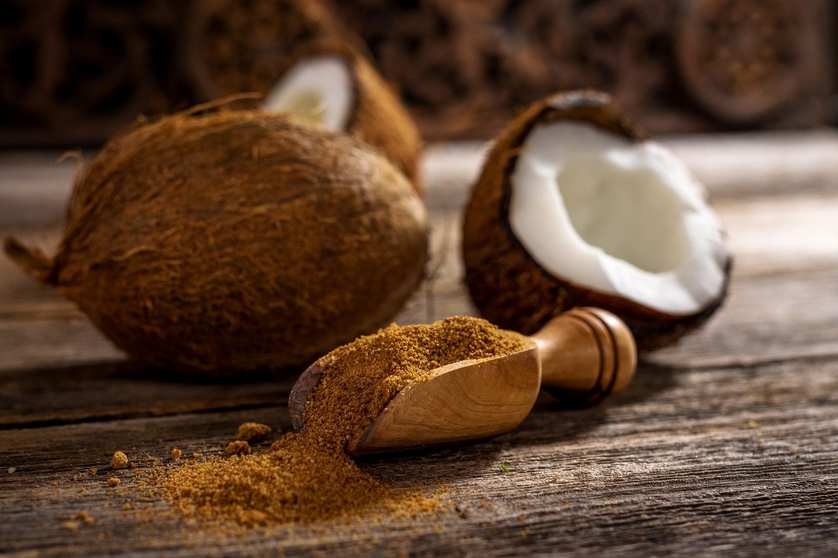 Coconut palm sugar on rustic wooden background