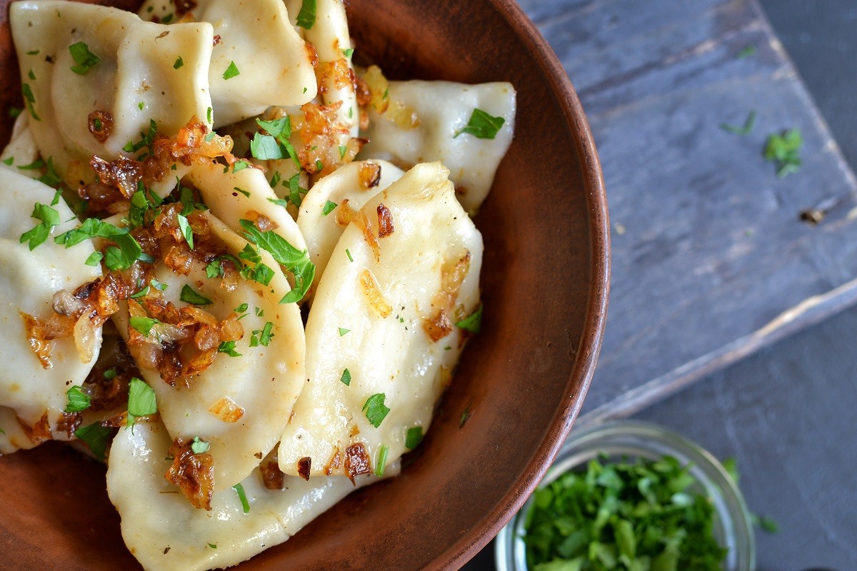 Dumplings with potato filling. Dumplings in a clay plate. Top view. Free space for text. Close up.
