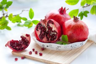 Pomegranates, whole and cut open
