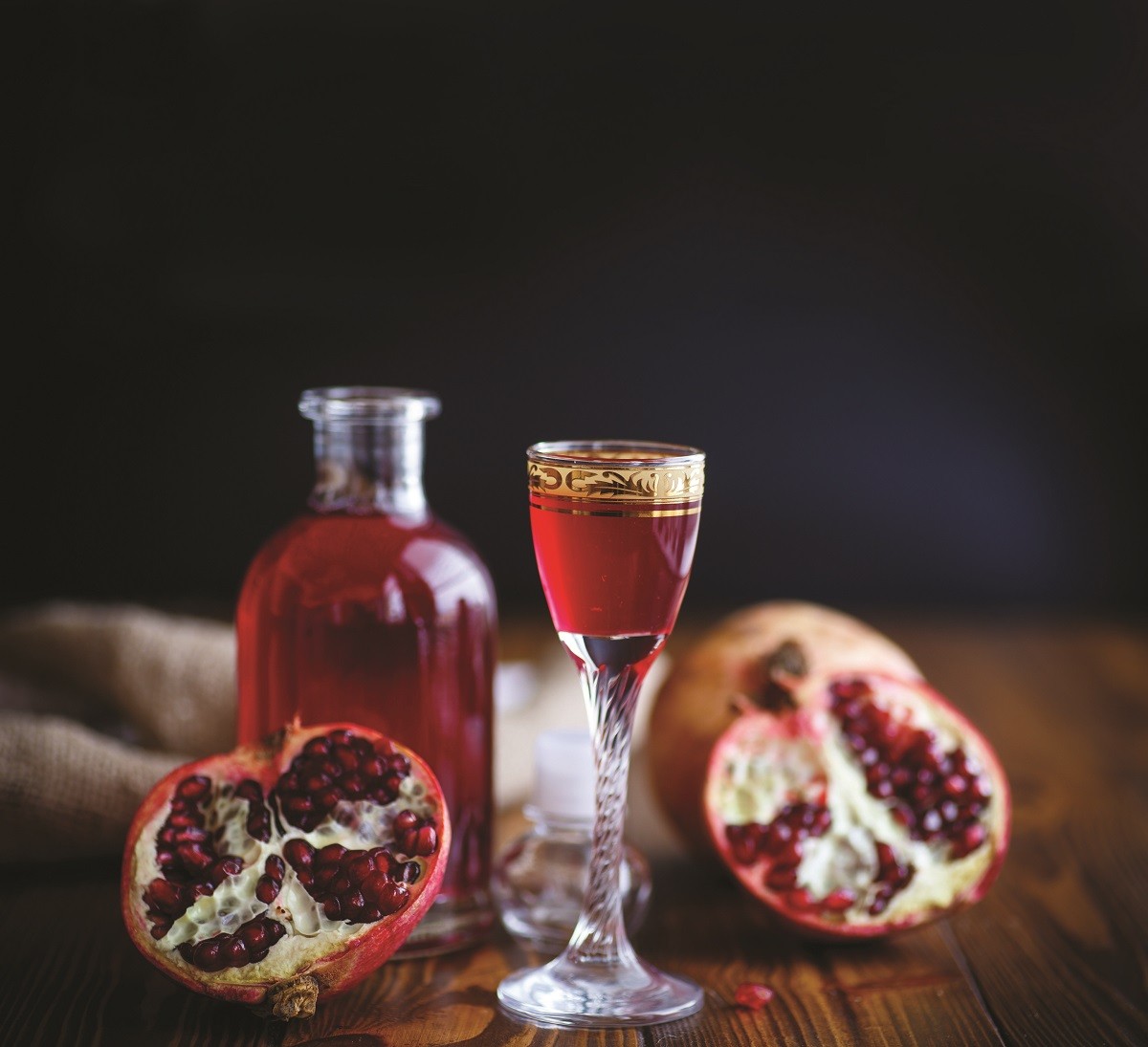 sweet pomegranate alcoholic cordial in the decanter with a glass