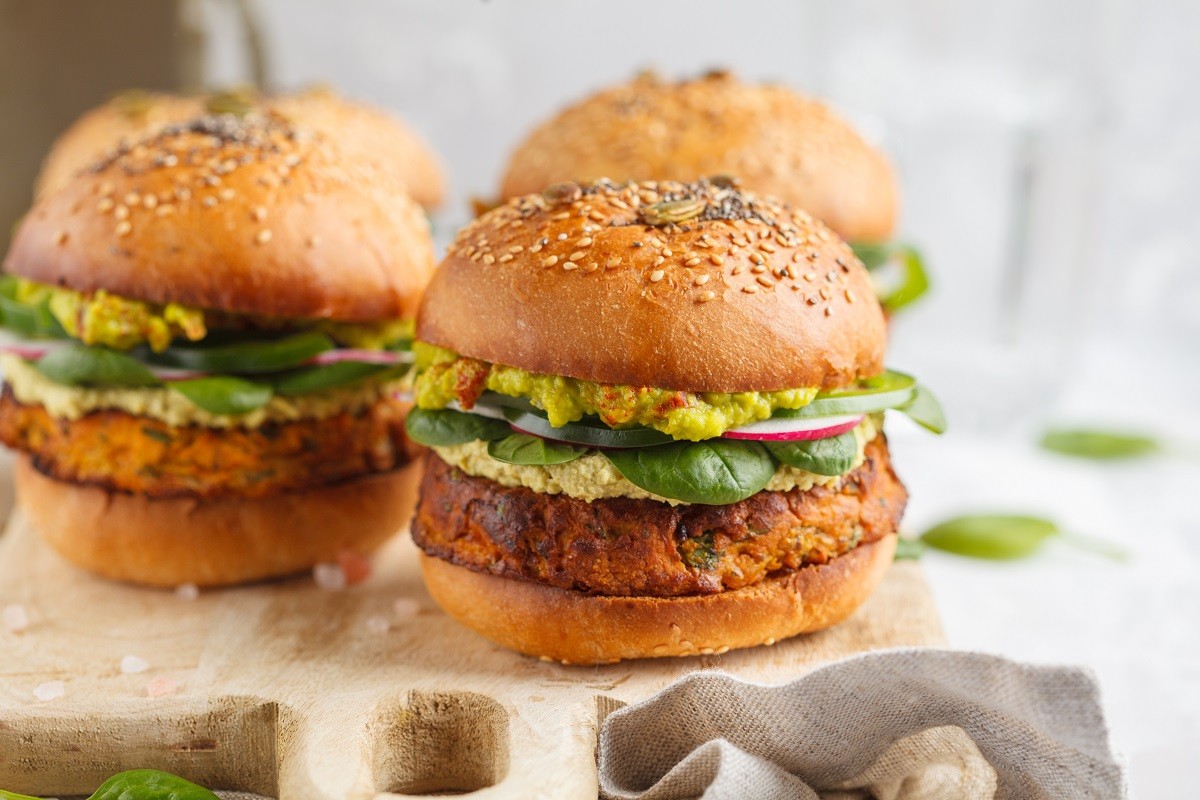 Healthy baked sweet potato burger with whole grain bun, guacamol