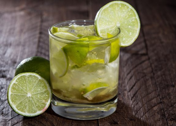 Glass with Caipirinha on wooden background