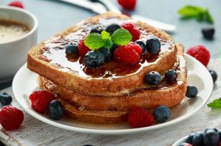 French cinnamon toast with blueberries, raspberries, maple syrup and coffee. morning breakfast