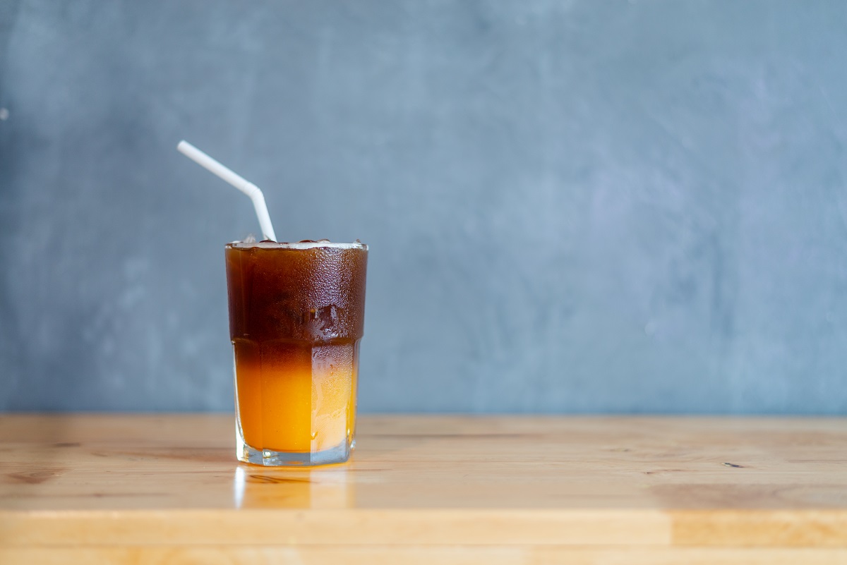 Ice coffee, americano coffee with orange in cafe.