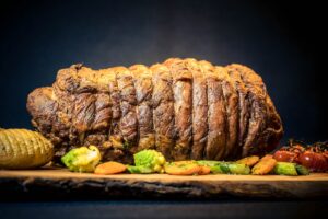 veal roll meat with spring vegetables and fan potatoes