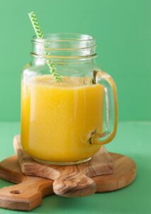 healthy mango pineapple smoothie in mason jars