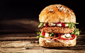 Burger Piled High with Toppings on Whole Grain Bun