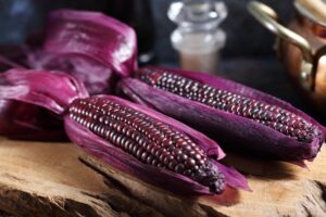 Boiled purple corn on wooden tray in rustic kitchen, Organic sweet purple corn