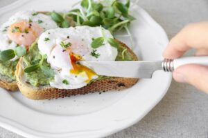 Poached eggs with avocado and sunflower sprout on sourdough toas