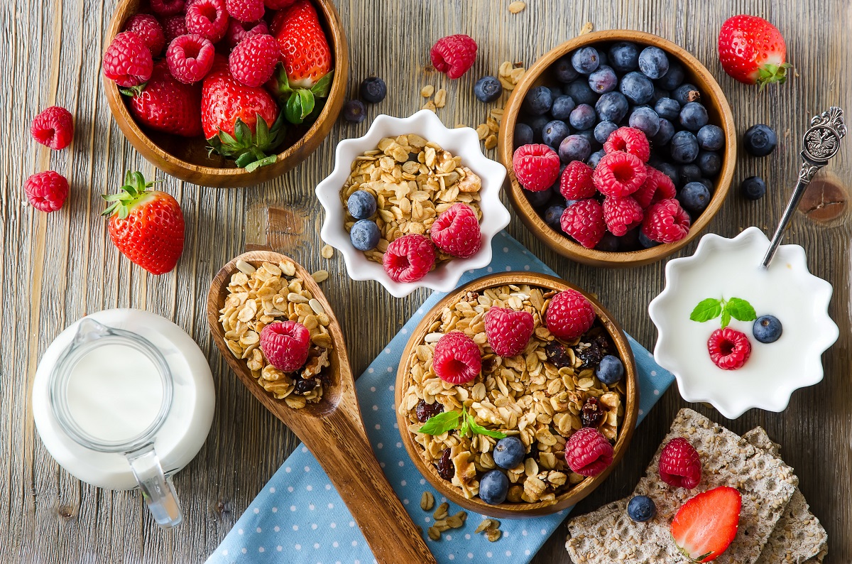 Fresh healthy breakfast with muesli and berries, vitamins, woode