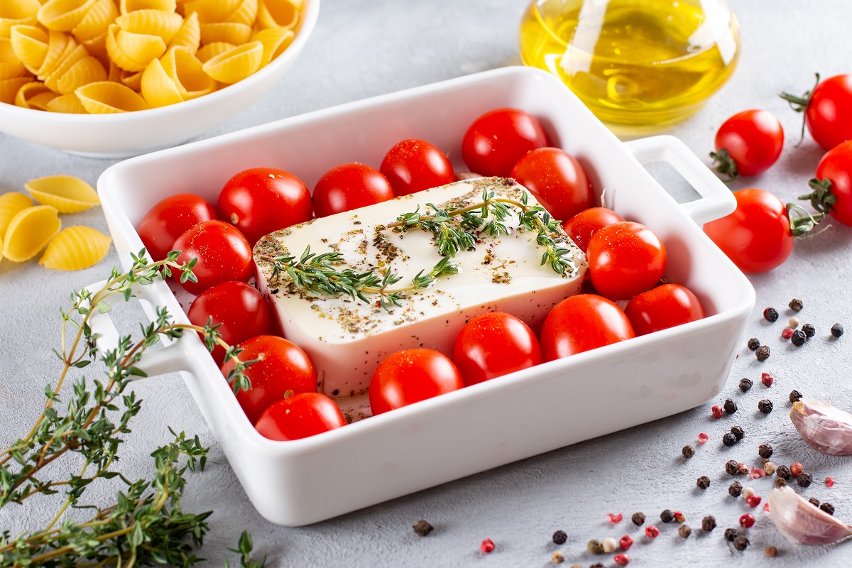 Preparation of ingredients for fetapasta. Trending Feta bake pasta recipe made of cherry tomatoes, feta cheese, garlic and herbs.