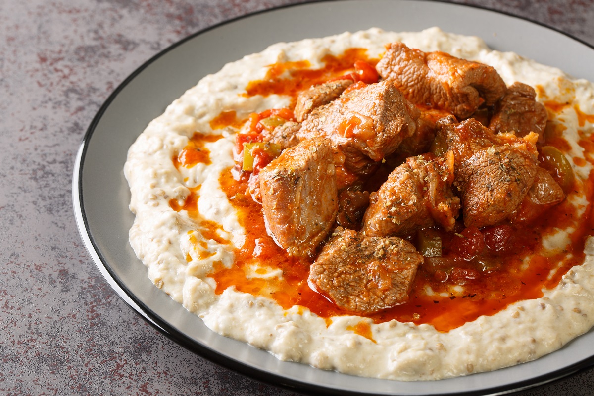 Turkish Hunkar Begendi meat on a bed of baked eggplant with bech