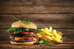 Delicious hamburger on wooden table