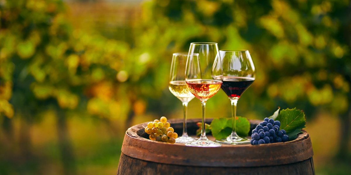 Three,Glasses,With,White,,Rose,And,Red,Wine,On,A