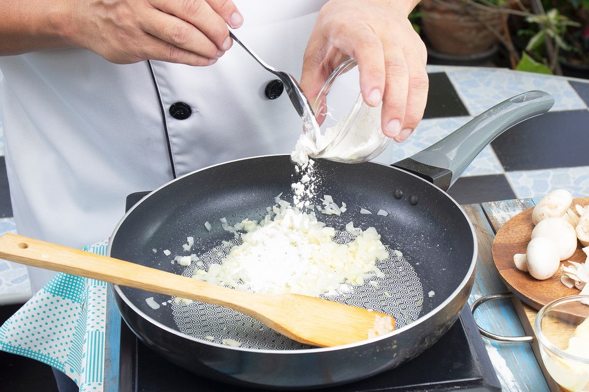 Chef,Putting,Flour,In,The,Pan,Prepared,For,Cooking,Mushroom