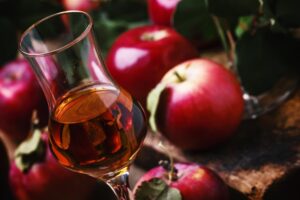 French,Strong,Golden,Alcoholic,Drink,From,Apples,,Vintage,Wooden,Background,