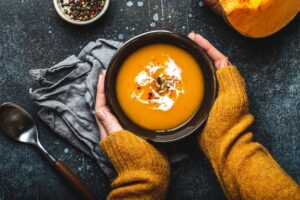 Female,Hands,In,Yellow,Knitted,Sweater,Holding,A,Bowl,With