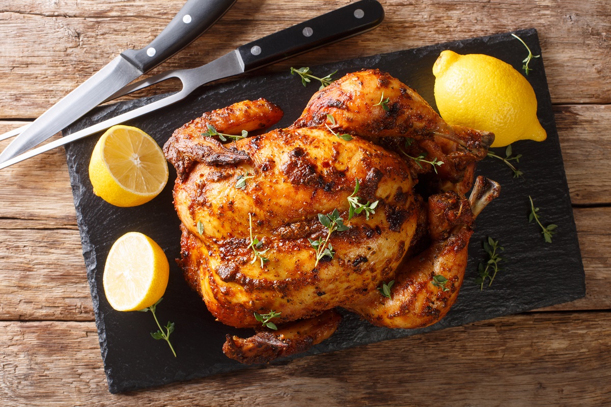 Homemade,Chicken,Rotisserie,With,Thyme,,Lemon,Closeup,On,A,Slate