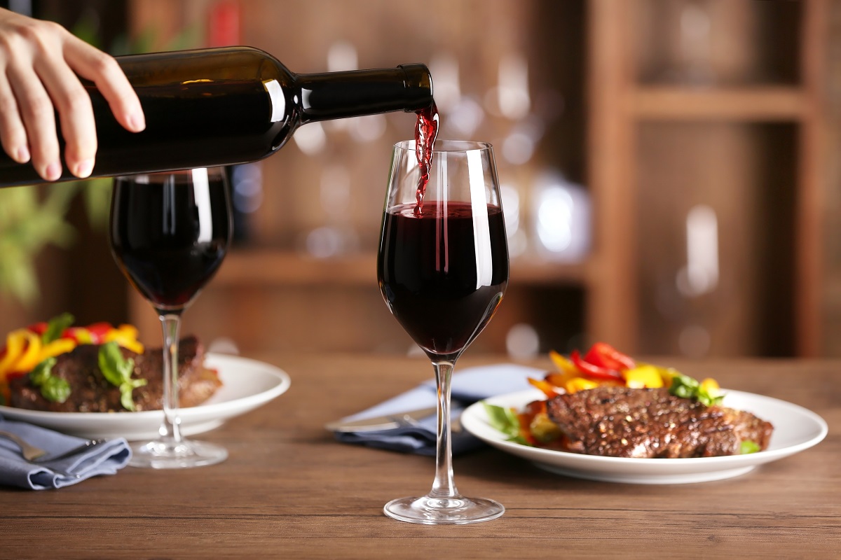 Pouring,Red,Wine,Into,Glass,At,Lunch,Time