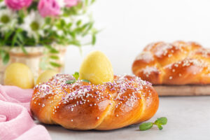 Happy,Easter.,Sweet,Easter,Bread,With,Colored,Eggs,And,Flowers.