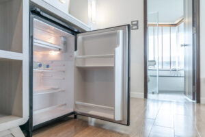 Opened,Small,Refrigerator,Under,The,Counter,And,In,Front,Of