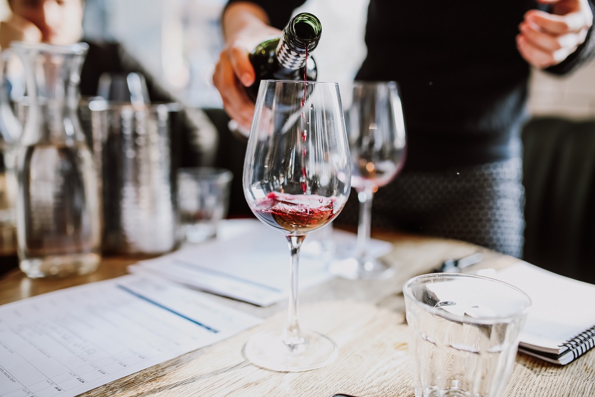 A,Close,Up,Shot,Of,A,Sommelier,Pouring,Red,Wine