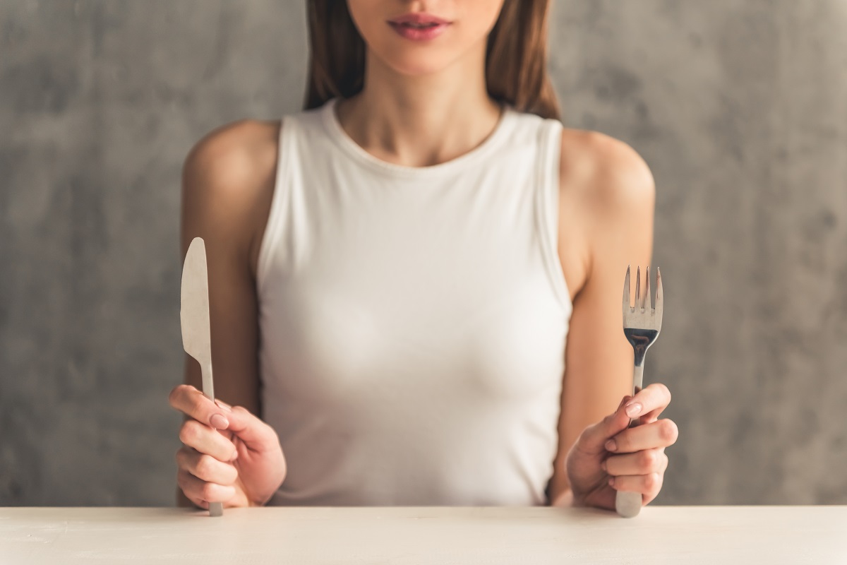 Eating,Disorder.,Girl,Is,Sitting,In,Front,Of,An,Empty