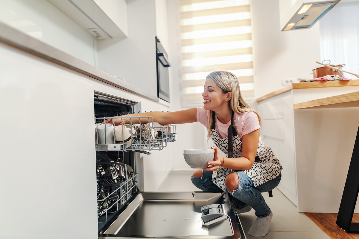 Worthy,Gorgeous,Smiling,Housewife,Crouching,In,Kitchen,And,Putting,Dishes