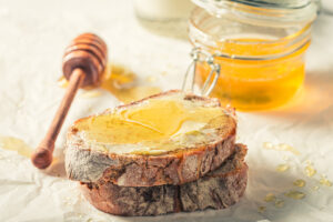 Delicious,Honey,Sandwich,With,Milk,For,Breakfast,On,Baking,Paper