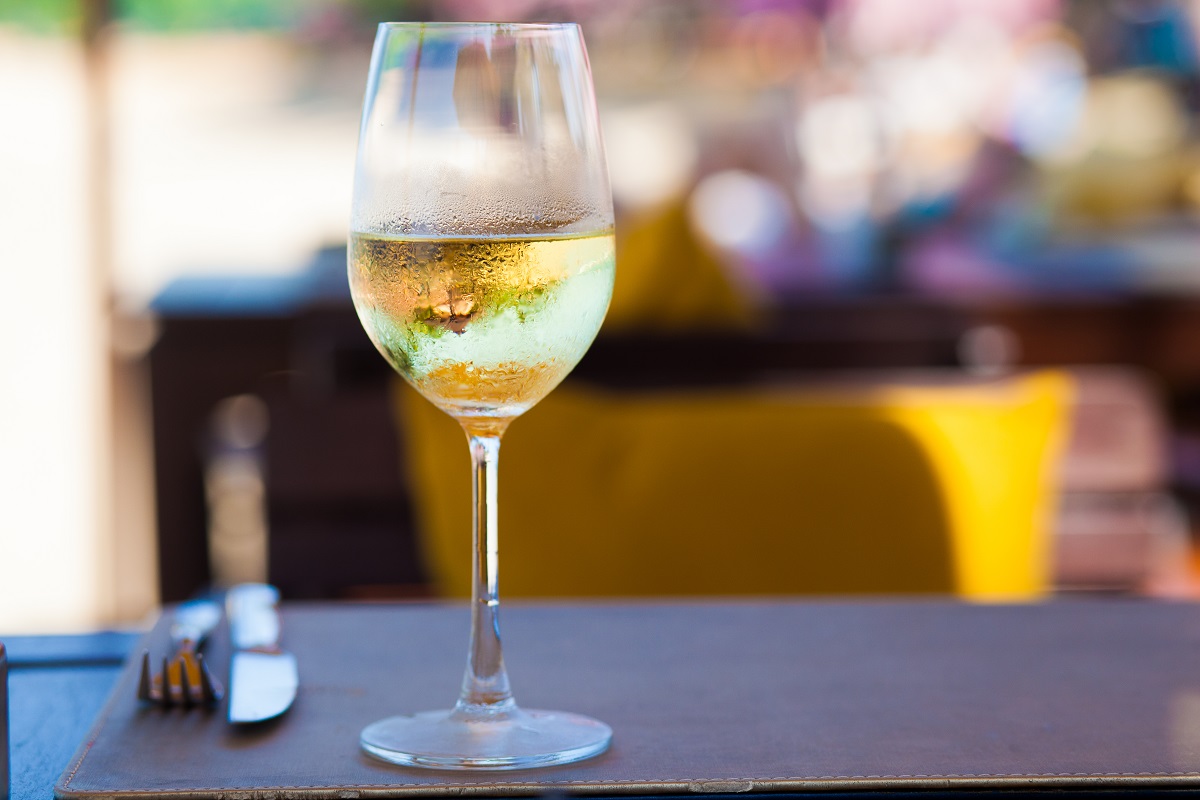 Glass,Of,Chilled,White,Wine,On,Table,Near,The,Beach