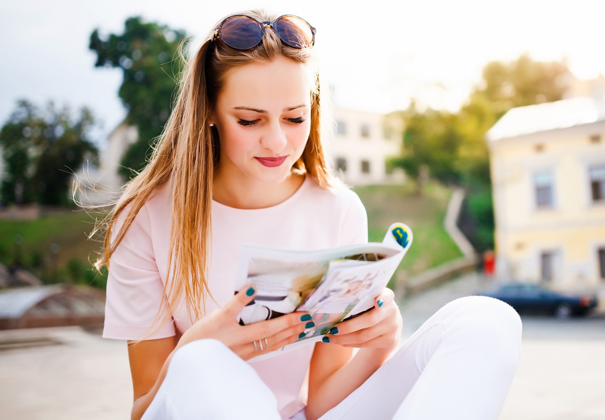 Outdoor,Portrait,Of,Young,Woman,Read,Fashion,Magazine