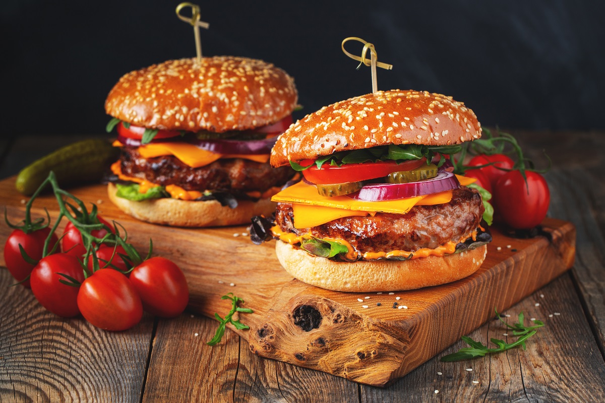 Two,Delicious,Homemade,Burgers,Of,Beef,,Cheese,And,Vegetables,On