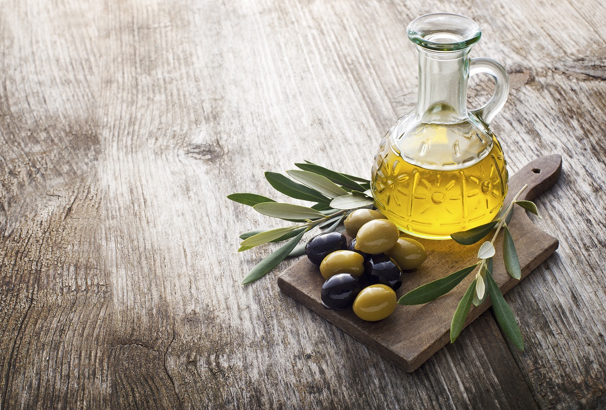 Olive,Oil,And,Olive,Branch,On,The,Wooden,Table