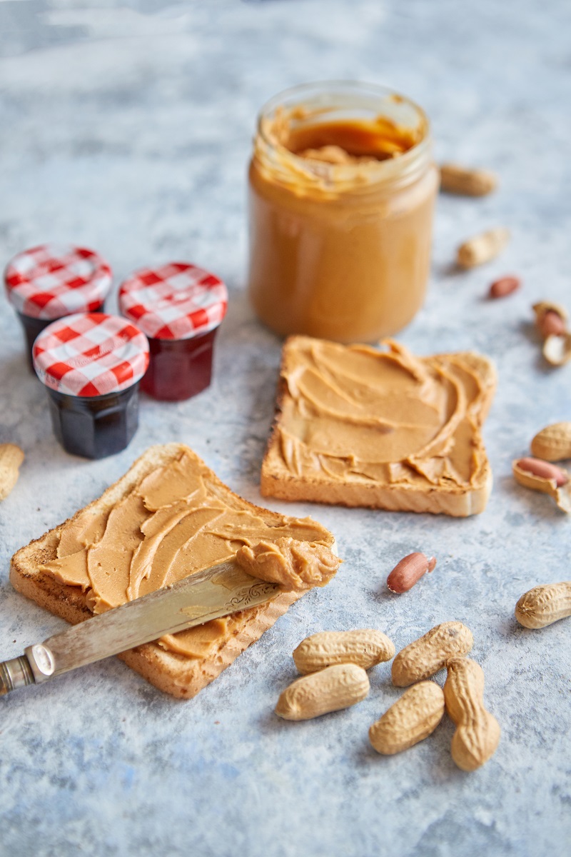 Two,Tasty,Peanut,Butter,Toasts,Placed,On,Stone,Table.,With