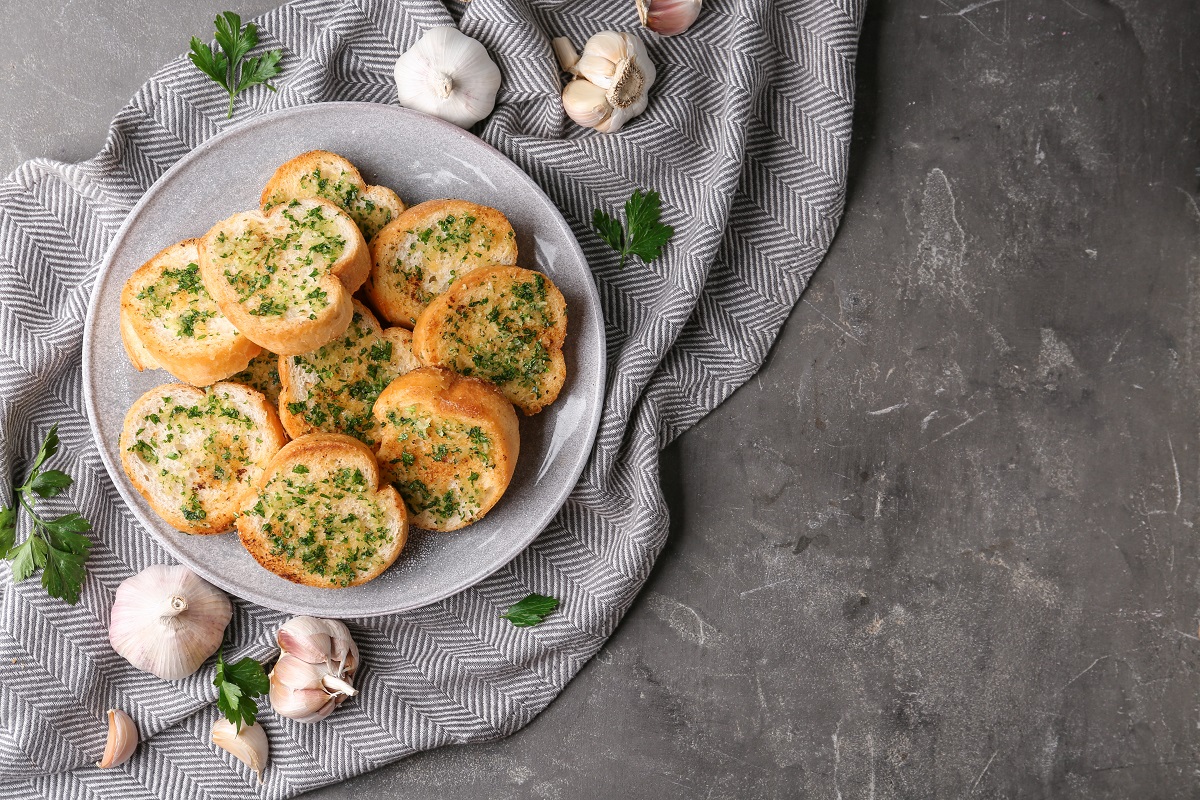 Slices,Of,Toasted,Bread,With,Garlic,And,Herbs,On,Grey