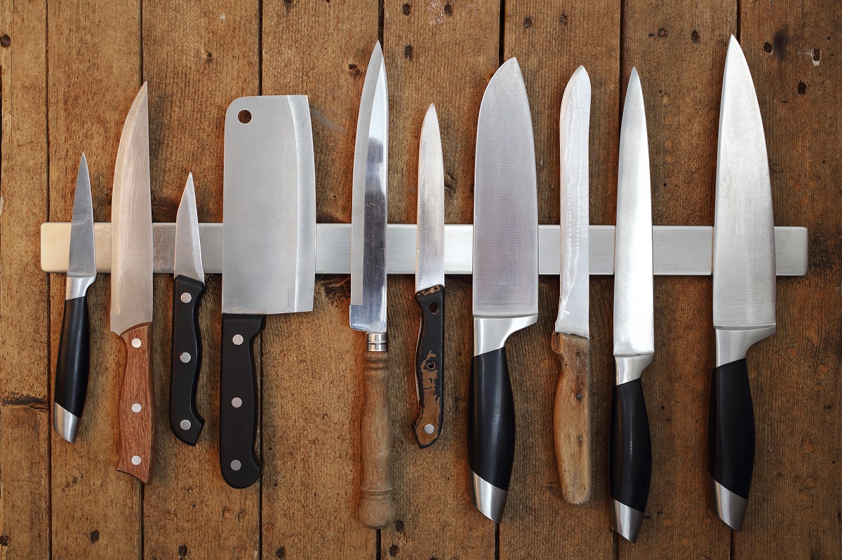 Collection,Of,Various,Kitchen,Knives,On,Magnetic,Tape