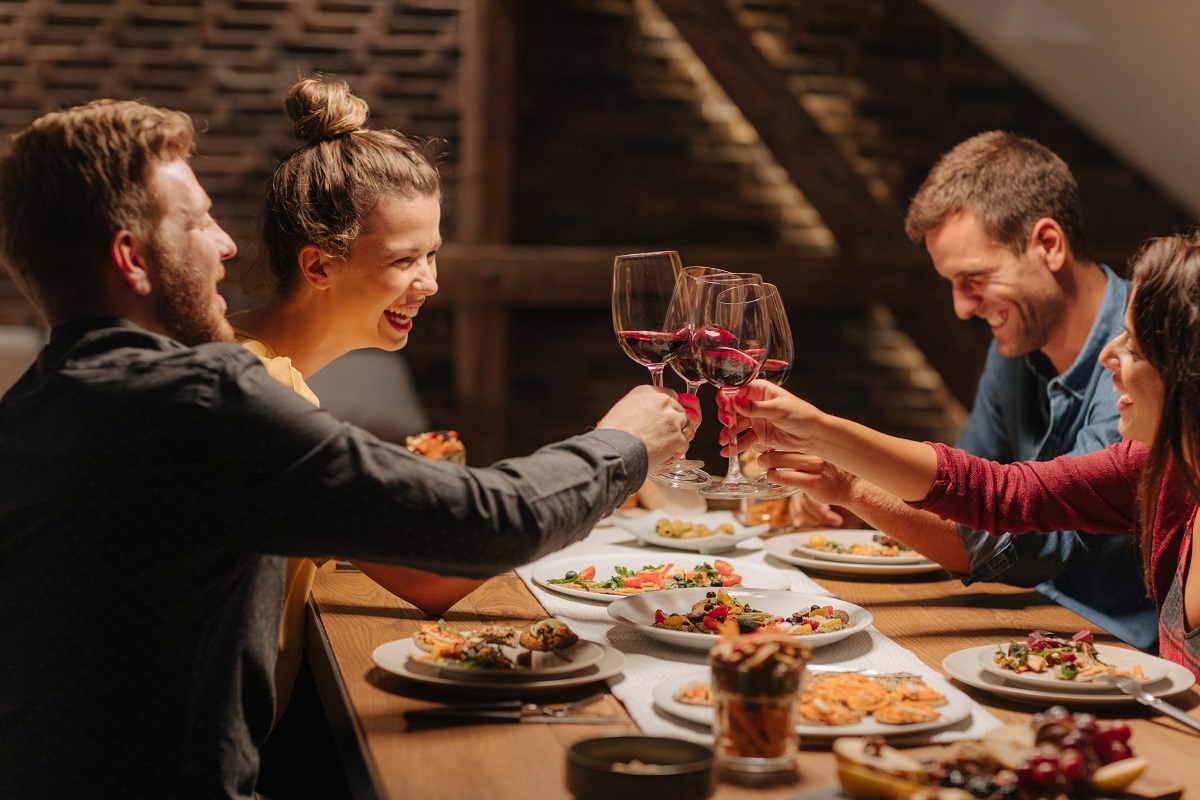 Group,Of,Friends,Toasting,With,Wine,Glasses,At,Home,Celebration