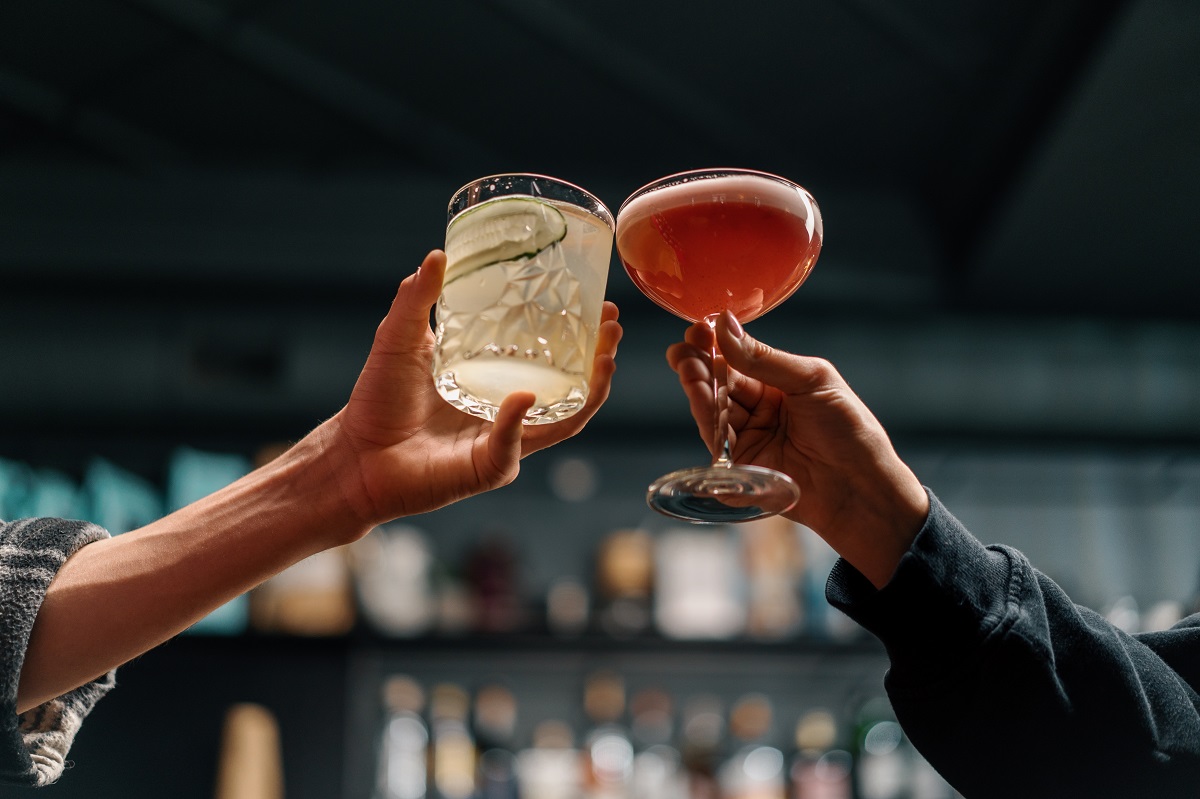 Close,Up,Of,Two,People,Cheering,Cocktails,In,Bar,Or